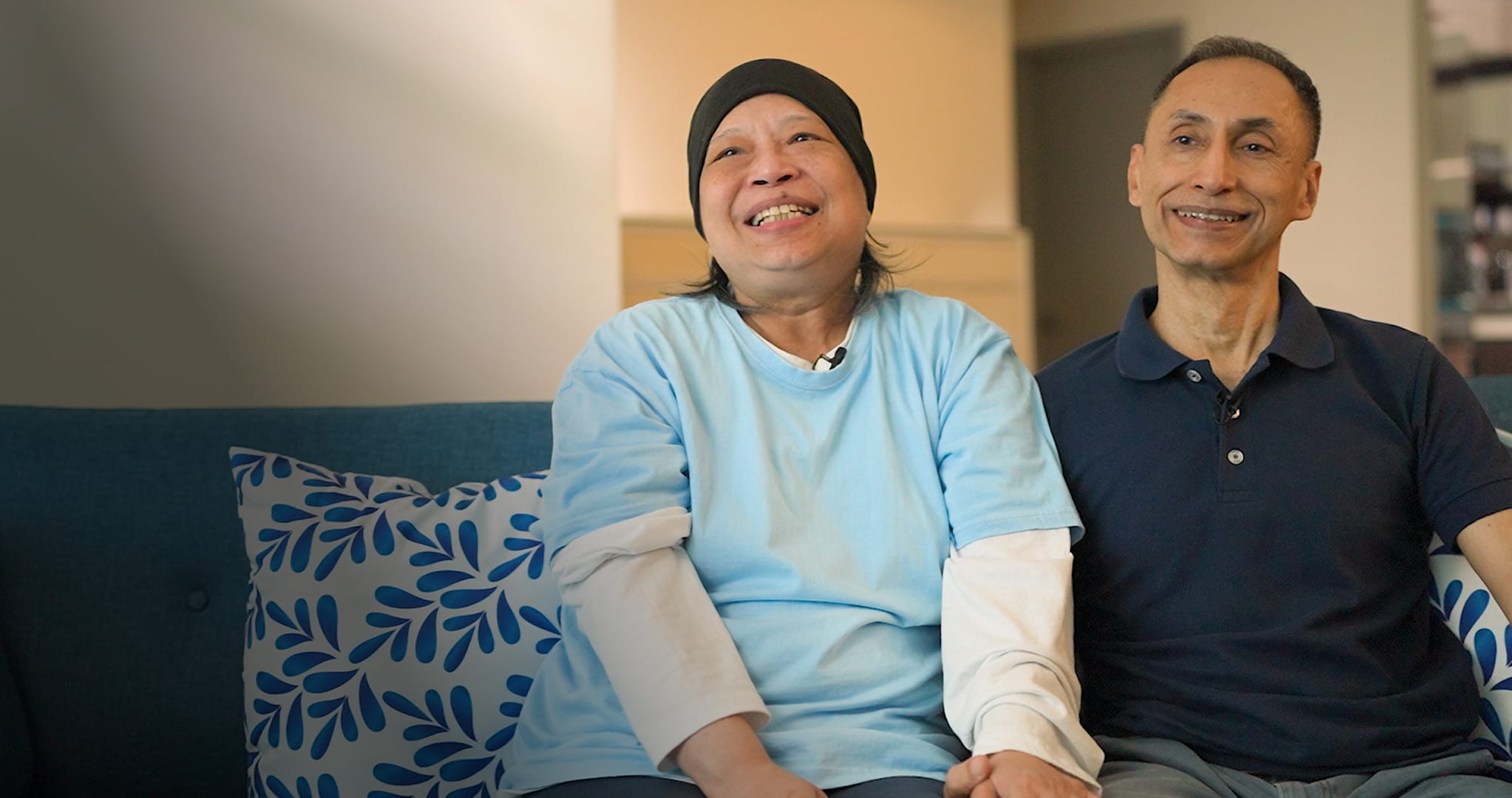 people, person, couch, adult, female, woman, hat, male, man, smile